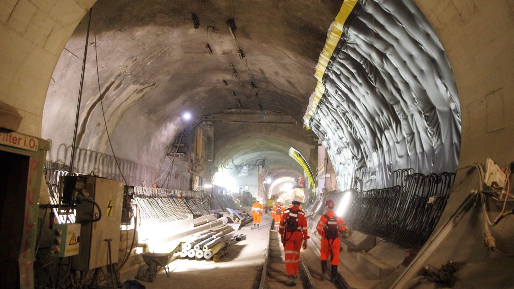 Construction crew inside a bored tunnel relying on temporary ventilation systems for tunnels